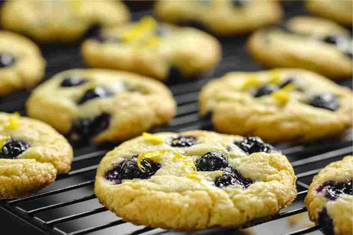 Freshly baked lemon blueberry cookies on a cooling rack