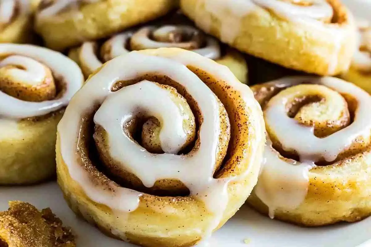 Single pie crust cinnamon roll with visible spiral layers and icing.